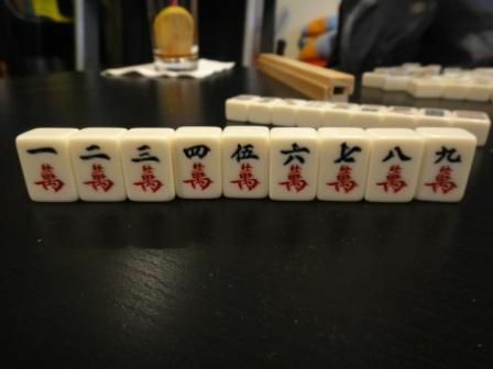 Karaktärsdräkten av en uppsättning Mahjong-brickor som sitter på ett bord.